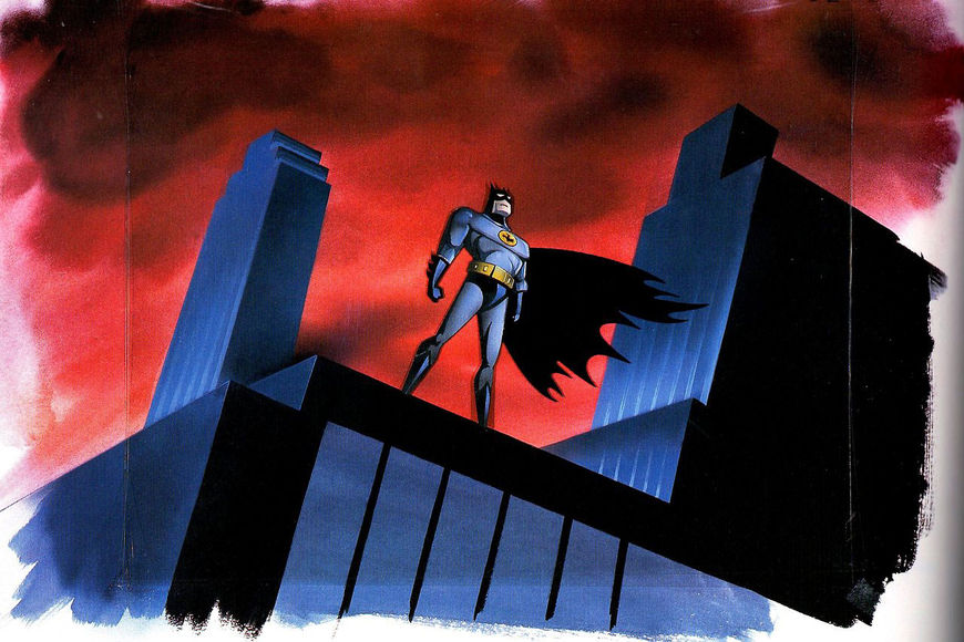 Batman stands atop the buildings of Gotham City.